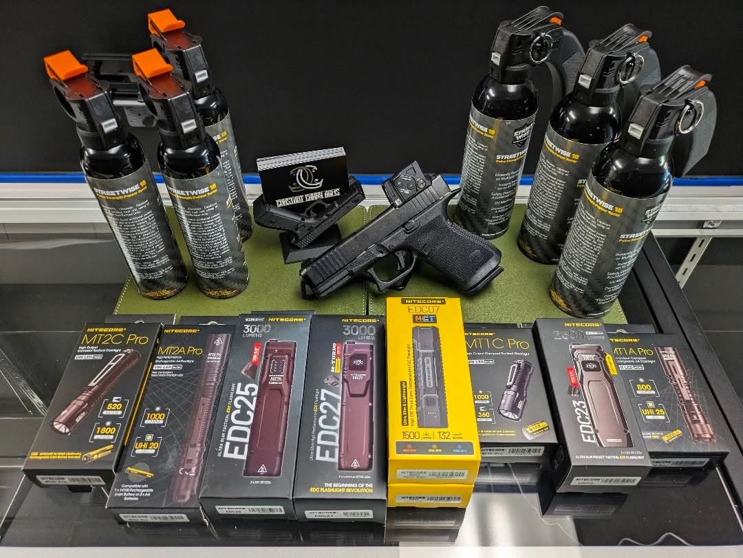 EDC gear display case with flashlights, knives, and everyday carry accessories